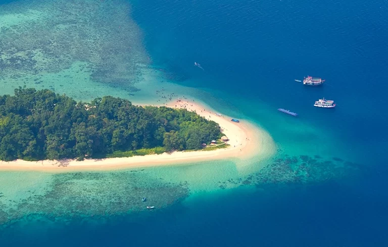 View from plane to Andaman Islands, an archipelago in the Bay of Bengal between India and Myanmar. There are a lot of people on beach.