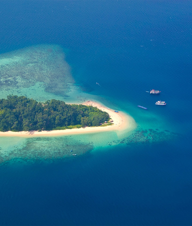 View from plane to Andaman Islands, an archipelago in the Bay of Bengal between India and Myanmar. There are a lot of people on beach.